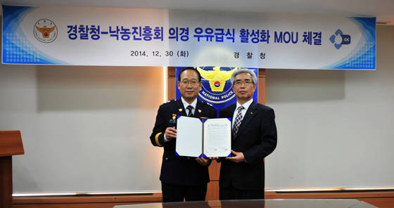 우유급식 업무협약을 맺은 경찰청 이중구 경비국장(왼쪽)과 낙농진흥회 이근성 회장(오른쪽) 