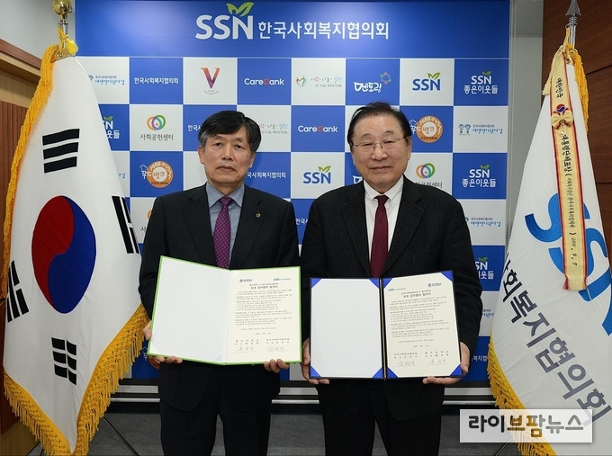 김관복 을지대학교 부총장(왼쪽)과 김성이 한국사회복지협의회장이 업무협약서를 들고 기념촬영을 하고 있다.
