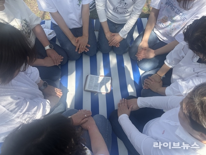 인천대공원 장미공원 옆에서 신천지 만수교회 성도들이 기도를 드리는 모습.(사진=신천지만수교회)
